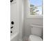 Modern bathroom with a toilet and white tub at 5010 Hyde Way, Cumming, GA 30040