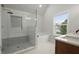 Bathroom featuring glass shower, soaking tub, and bright window lighting at 5010 Hyde Way, Cumming, GA 30040