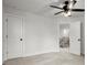 Bright, carpeted bedroom featuring a ceiling fan and a doorway leading to the hallway at 5010 Hyde Way, Cumming, GA 30040