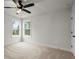 Bedroom featuring plush carpet, natural light from two windows, and a ceiling fan at 5010 Hyde Way, Cumming, GA 30040