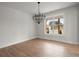 Spacious dining room featuring hardwood floors and a large window with natural light at 5010 Hyde Way, Cumming, GA 30040