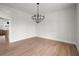 Large dining room with hardwood floors and a decorative chandelier at 5010 Hyde Way, Cumming, GA 30040
