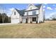 Beautiful home with a well-manicured lawn, a two-car garage, and inviting front porch at 5010 Hyde Way, Cumming, GA 30040
