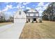 Farmhouse style home featuring a 2-car garage and covered porch at 5010 Hyde Way, Cumming, GA 30040