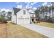 Farmhouse style home featuring a 2-car garage and covered porch at 5010 Hyde Way, Cumming, GA 30040