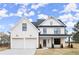 Charming two-story home with white siding, black trim, and inviting front porch at 5010 Hyde Way, Cumming, GA 30040