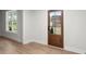 The interior features a wood door, hardwood floors, and a window providing natural light at 5010 Hyde Way, Cumming, GA 30040