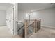 Upstairs hallway features a wood and iron railing at 5010 Hyde Way, Cumming, GA 30040