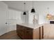 Modern kitchen with white cabinets and large island at 5010 Hyde Way, Cumming, GA 30040