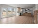 Bright, open-concept kitchen with white cabinetry, stainless steel appliances, and wood flooring at 5010 Hyde Way, Cumming, GA 30040