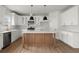 Modern kitchen with white cabinets, stainless steel appliances, and a center island at 5010 Hyde Way, Cumming, GA 30040