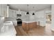 Stylish kitchen featuring white cabinets, stainless steel appliances, and a center island at 5010 Hyde Way, Cumming, GA 30040