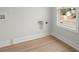 Functional laundry room features durable laminate flooring, natural light, and washer and dryer hookups at 5010 Hyde Way, Cumming, GA 30040