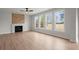 Spacious living room with a fireplace, wood floors, and large windows at 5010 Hyde Way, Cumming, GA 30040