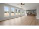 Open living space featuring wood floors, a view of the kitchen, and large windows at 5010 Hyde Way, Cumming, GA 30040