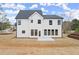 Striking two-story home with white siding, dark trim, and a well-manicured lawn at 5010 Hyde Way, Cumming, GA 30040