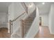 Staircase with wood and black iron balusters and lots of light at 5010 Hyde Way, Cumming, GA 30040