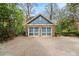 Detached two-car garage featuring stone accents, double doors, and a paved driveway at 1040 Amsterdam Ne Ave, Atlanta, GA 30306