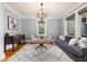 Living room with hardwood floors, gray sofa, decorative rug and wooden cabinet at 1040 Amsterdam Ne Ave, Atlanta, GA 30306