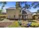 A well-maintained backyard with a brick patio, fire pit, and a manicured lawn at 1151 Adah Ln, Lawrenceville, GA 30043