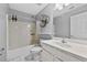 Traditional bathroom features a combined shower and tub with a white sink vanity, and tiled flooring at 1151 Adah Ln, Lawrenceville, GA 30043
