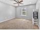 Cozy bedroom with a ceiling fan, plush carpet, and natural light creating a relaxing atmosphere at 1151 Adah Ln, Lawrenceville, GA 30043