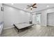 Bright bedroom with sliding barn door to outdoor access and tile floor; ceiling fan included at 1151 Adah Ln, Lawrenceville, GA 30043
