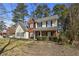 Beautifully landscaped, two-story home with a brick and siding exterior and a cozy front porch at 1151 Adah Ln, Lawrenceville, GA 30043