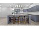 Modern kitchen boasts an island with stool seating, granite countertops, and stainless steel appliances at 1151 Adah Ln, Lawrenceville, GA 30043