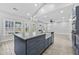 Gourmet kitchen with gray island, stainless appliances, and eat-in bar, open to the living area at 1151 Adah Ln, Lawrenceville, GA 30043