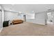 Spacious and bright living room with carpet and a comfortable leather sofa at 1151 Adah Ln, Lawrenceville, GA 30043