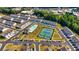 Aerial view of the community featuring a pool, tennis courts, and manicured lawns at 228 Auburn Valley Way, Auburn, GA 30011