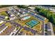 Aerial view of the community featuring a pool, tennis courts, and manicured lawns at 228 Auburn Valley Way, Auburn, GA 30011