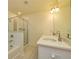 Bright bathroom featuring a double vanity, large mirror and tiled shower and tub at 228 Auburn Valley Way, Auburn, GA 30011