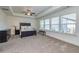 Spacious bedroom with a tray ceiling, large windows, and neutral carpeting at 228 Auburn Valley Way, Auburn, GA 30011