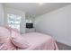 Comfortable bedroom features carpet, natural light, a dresser and television at 228 Auburn Valley Way, Auburn, GA 30011