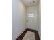 Inviting entryway featuring wood floors, a white door with glass, and neutral paint at 228 Auburn Valley Way, Auburn, GA 30011