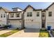 Attractive townhomes featuring painted white brick, black trim and a convenient one-car garage at 228 Auburn Valley Way, Auburn, GA 30011