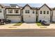 Charming townhomes featuring a white brick facade, two stories, and individual one-car garages at 228 Auburn Valley Way, Auburn, GA 30011