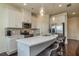 Modern kitchen features white cabinets, stainless steel appliances, and a quartz countertop island with bar seating at 228 Auburn Valley Way, Auburn, GA 30011