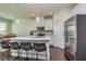 Open kitchen featuring a large island with seating, stainless steel appliances, and white cabinets at 228 Auburn Valley Way, Auburn, GA 30011