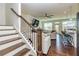 Stylish staircase flowing into a modern living room with lots of light and hardwood floors at 228 Auburn Valley Way, Auburn, GA 30011