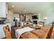 Open-concept living space with a fireplace and TV connected to a dining area and kitchen at 228 Auburn Valley Way, Auburn, GA 30011