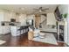 Open concept living space featuring a modern kitchen, living room with fireplace, and hardwood floors at 228 Auburn Valley Way, Auburn, GA 30011