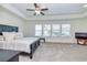 Spacious main bedroom features a tray ceiling, carpet, and large windows at 228 Auburn Valley Way, Auburn, GA 30011