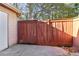This backyard has a concrete floor, a wooden fence and gate, and a door at 386 Northdale Ct, Lawrenceville, GA 30046
