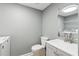 This bathroom has a toilet, a sink with a mirror, and a laundry machine at 386 Northdale Ct, Lawrenceville, GA 30046