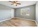 Spacious bedroom with a ceiling fan and large window offering natural light at 386 Northdale Ct, Lawrenceville, GA 30046