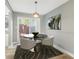 Cozy dining area with modern lighting and sliding glass doors to outdoor space at 386 Northdale Ct, Lawrenceville, GA 30046