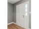 Neutral gray entry with wood look floors and a white front door with sidelight at 386 Northdale Ct, Lawrenceville, GA 30046